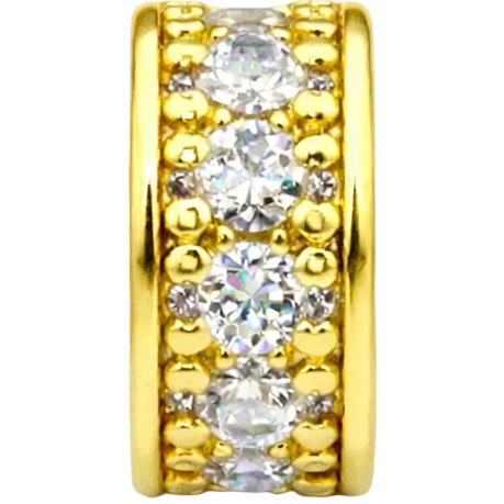 Gold ring with three clear gemstones on a white background