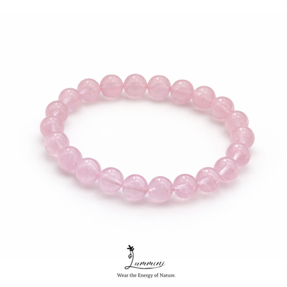 Pink beaded bracelet on a white background with 'Lumini' branding.