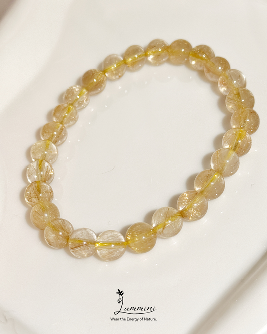Yellow beaded bracelet on a white background with 'Lummini' branding.